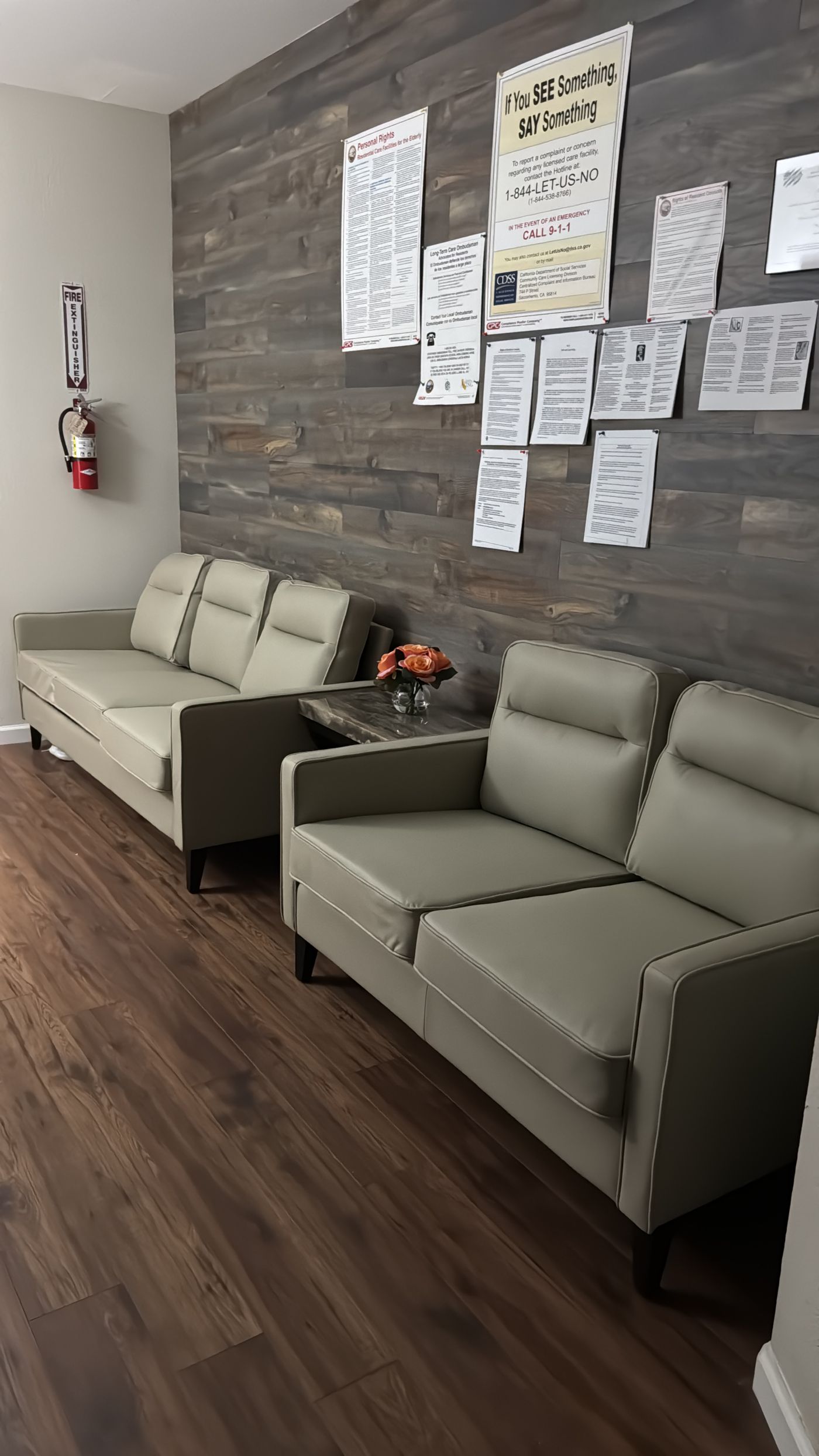 Entryway seating area at Whale CA with resident rights and California licensing notices posted on the wall.